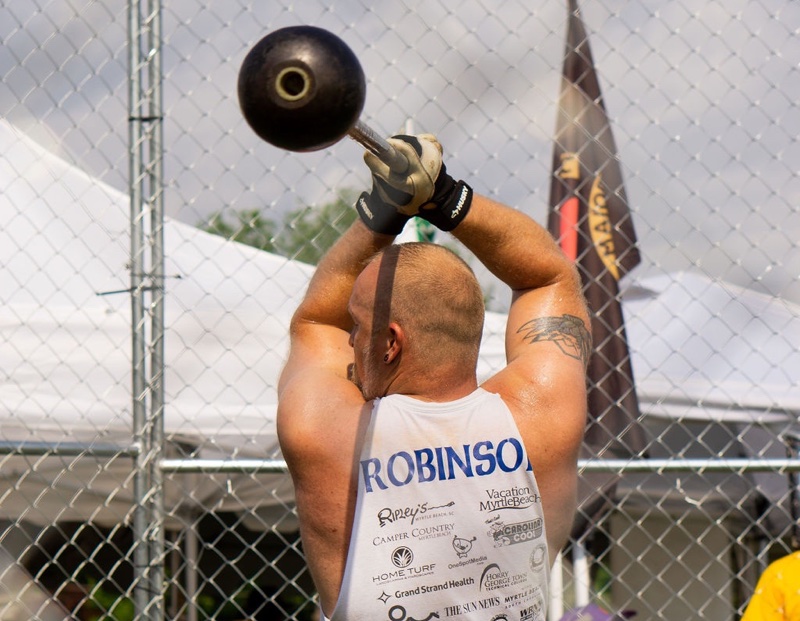 man holding light hammer in heavy athletics competition